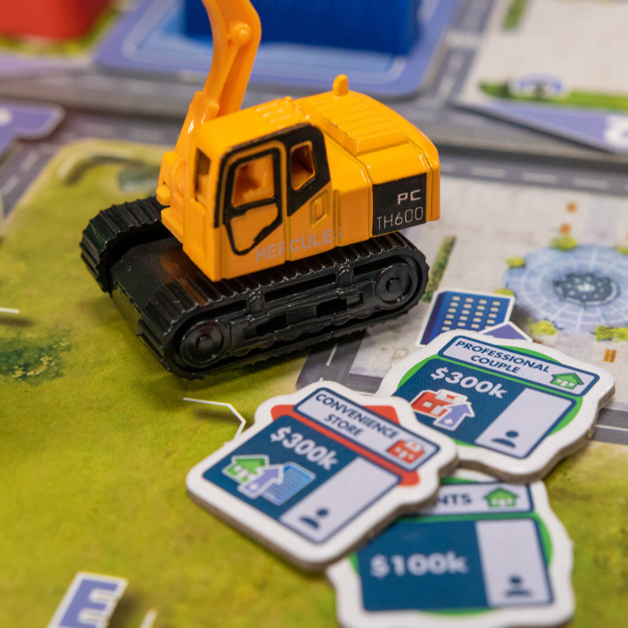 Magnate: The First City family economy builing game excavator on map with tokens